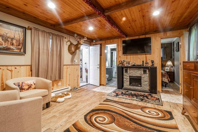 living room with a baseboard heating unit, wooden ceiling, wooden walls, and light wood finished floors