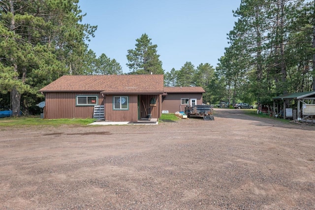 single story home featuring a carport