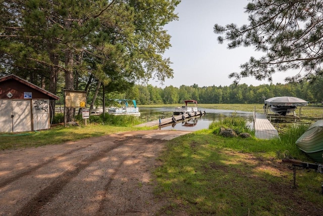 view of community featuring a boat dock, a water view, and boat lift