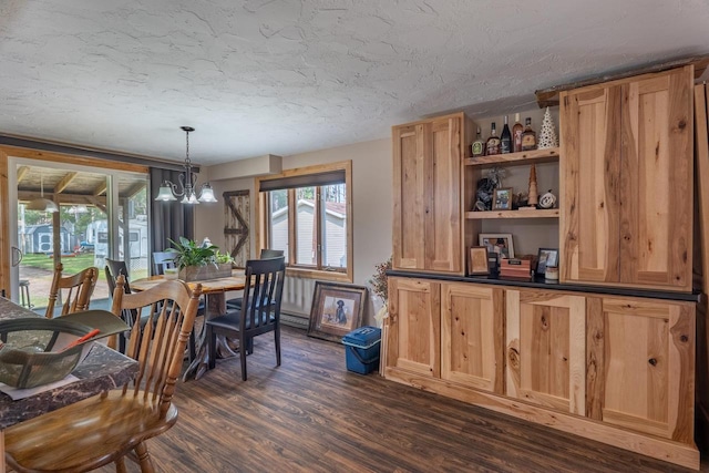 dining space with dark wood-type flooring, a notable chandelier, and a textured ceiling