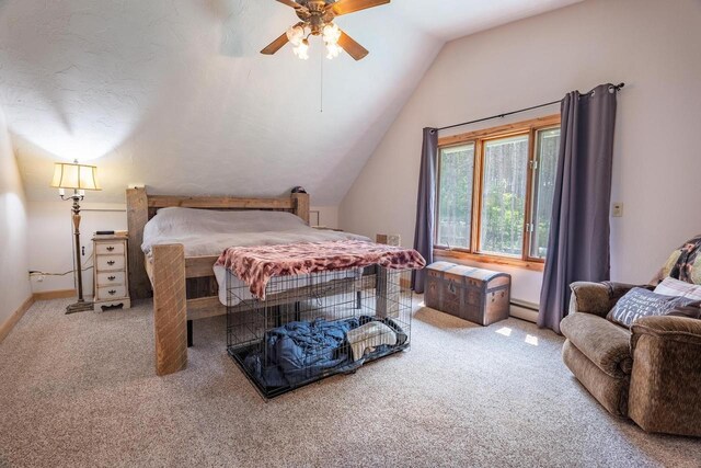 carpeted bedroom with ceiling fan, vaulted ceiling, and baseboard heating