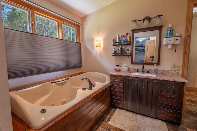 bathroom featuring a bath, tile patterned flooring, and vanity