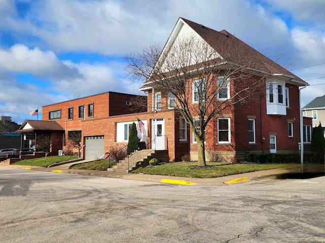 view of front of property featuring brick siding and an attached garage