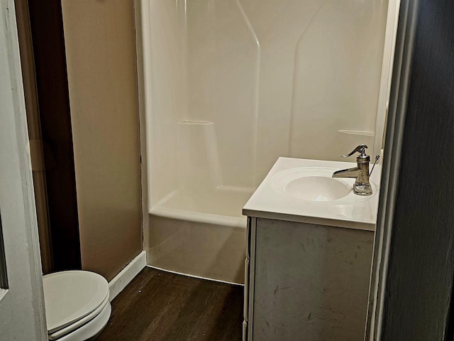 full bath with toilet, vanity, and wood finished floors