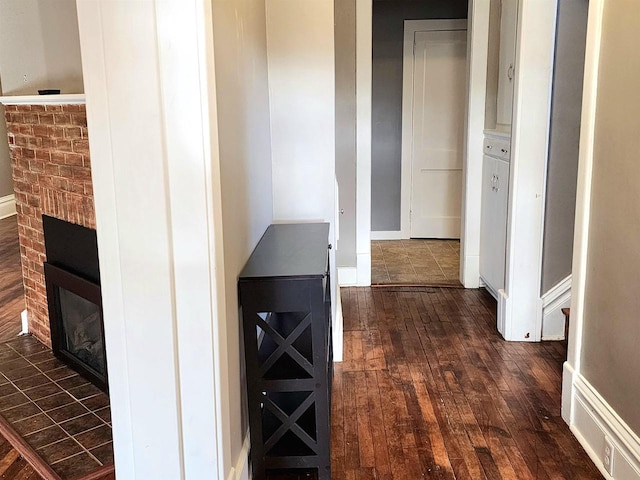 hall with dark wood-style flooring