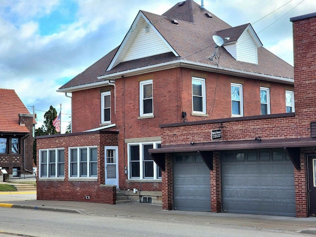 exterior space with brick siding and an attached garage