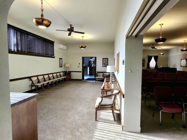 carpeted living room featuring a ceiling fan and a wall unit AC