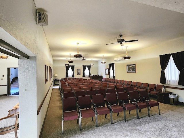 carpeted cinema room with baseboards and ceiling fan