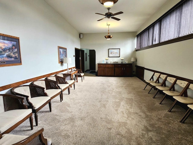 living area with light colored carpet and ceiling fan