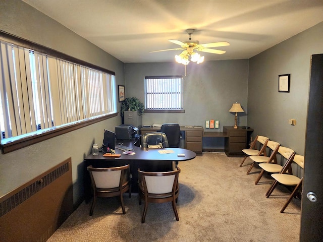 home office with light colored carpet, radiator, and a ceiling fan