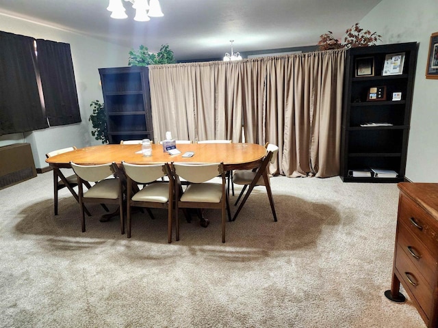 carpeted dining space with a notable chandelier