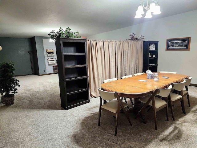 dining area featuring light colored carpet, baseboards, and a chandelier