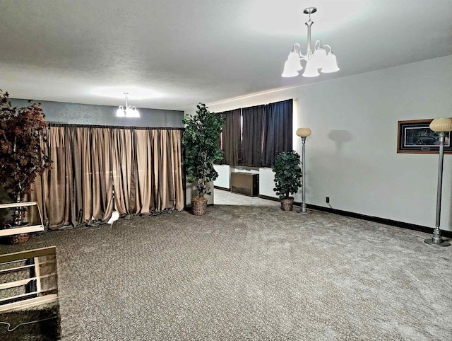 interior space with a notable chandelier, baseboards, and a textured ceiling