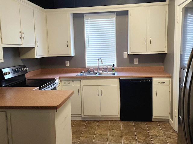 kitchen featuring a sink, white cabinetry, dishwasher, and electric stove