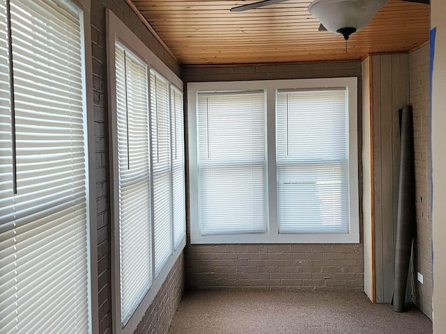 unfurnished sunroom featuring wood ceiling