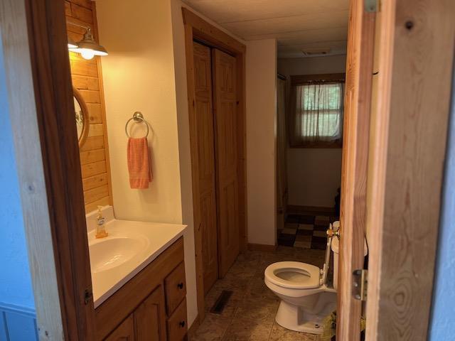 bathroom featuring tile patterned flooring, vanity, and toilet