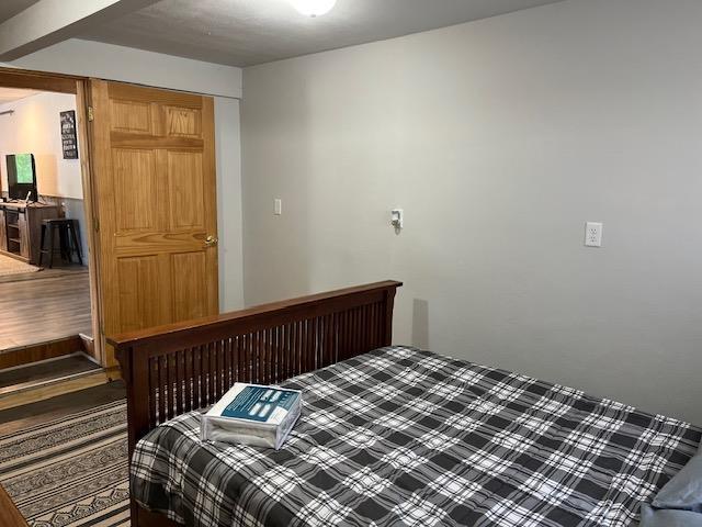 bedroom with wood-type flooring