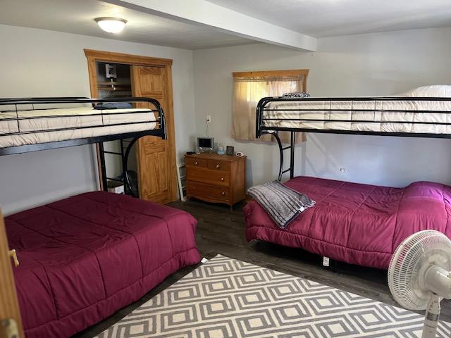 bedroom with dark hardwood / wood-style floors