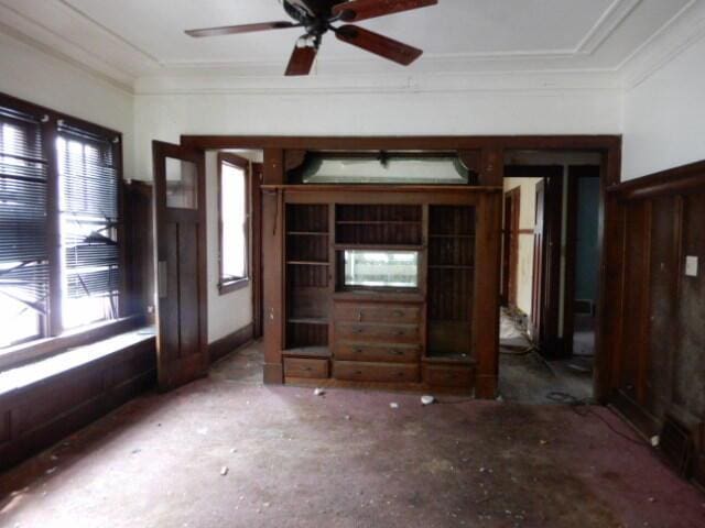 interior space featuring a ceiling fan and crown molding