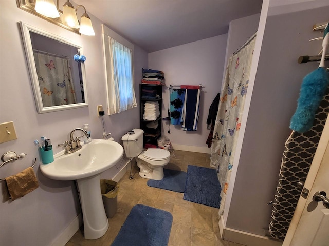 bathroom with tile patterned flooring, toilet, and a shower with shower curtain