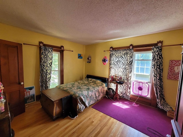 bedroom featuring wood-type flooring and a textured ceiling