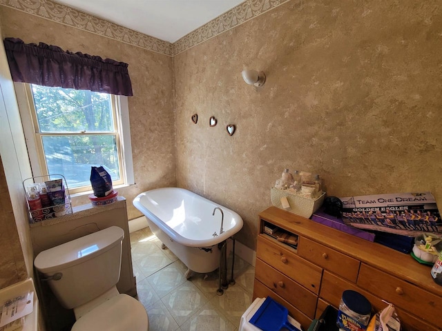 bathroom featuring toilet and a tub to relax in