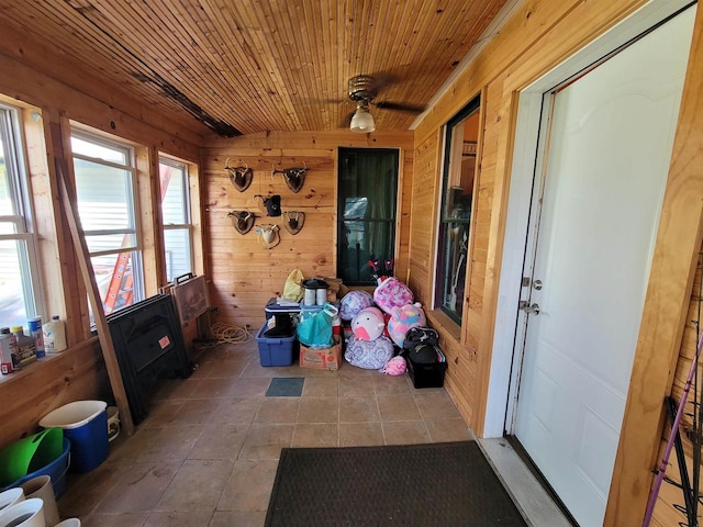 sunroom with ceiling fan and wooden ceiling