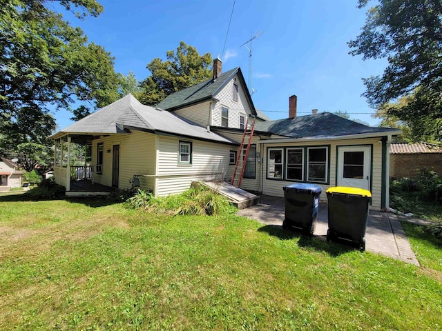 rear view of property featuring a yard