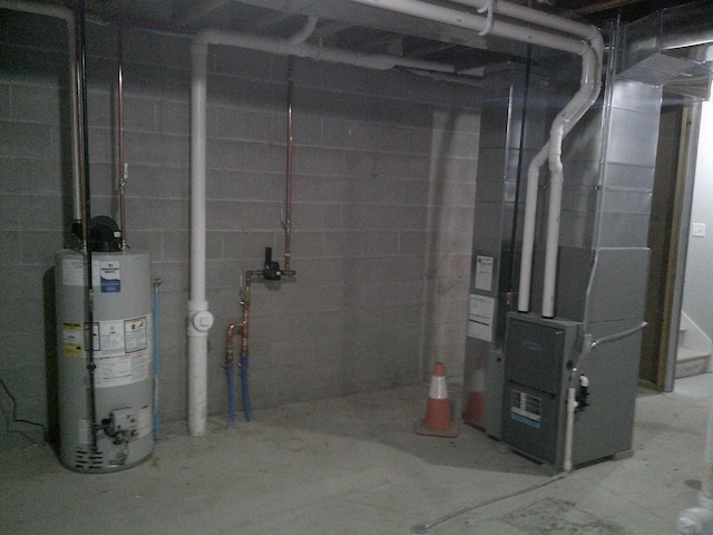 unfinished basement featuring heating unit and gas water heater