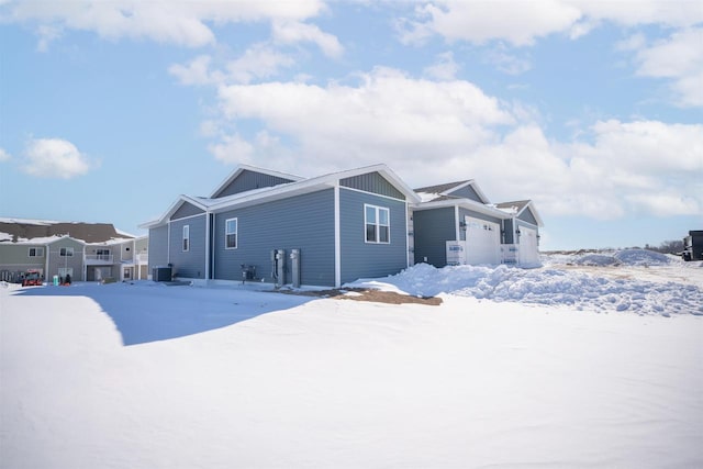 exterior space featuring board and batten siding, a residential view, and central AC unit