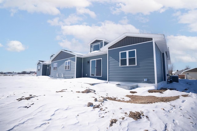 view of front facade featuring board and batten siding and central AC