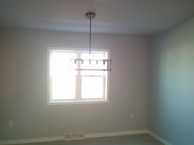 spare room with visible vents and baseboards