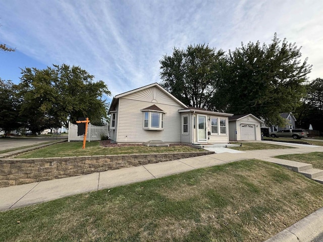 view of front of property featuring a front lawn and a garage