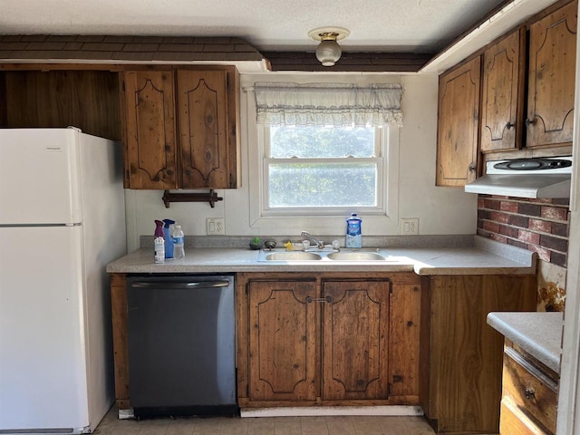 N9185 9th Ave, New Lisbon, WI 53950 - kitchen with dishwashing machine, freestanding refrigerator, a sink, and brown cabinets