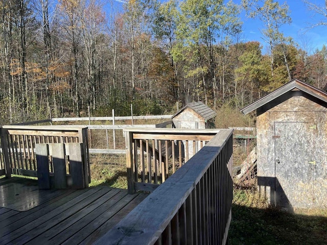 N9185 9th Ave, New Lisbon, WI 53950 - wooden deck with a storage shed, an outdoor structure, and a view of trees