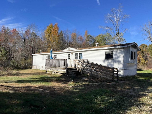 N9185 9th Ave, New Lisbon, WI 53950 - rear view of house with a deck and a yard