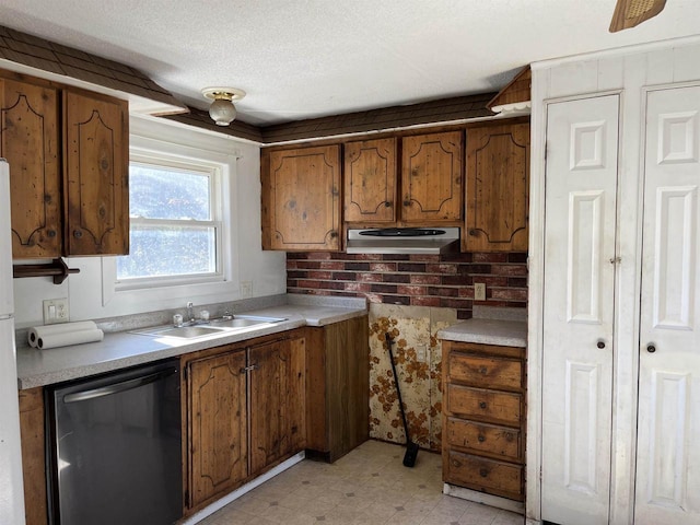 N9185 9th Ave, New Lisbon, WI 53950 - kitchen with dishwasher, a sink, brown cabinets, light flooring, and a textured ceiling