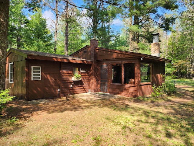 rear view of house featuring a lawn