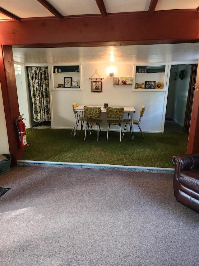 dining area with beam ceiling and carpet