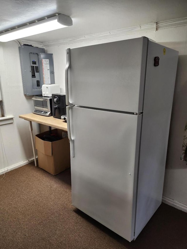 kitchen with carpet floors, white refrigerator, and electric panel