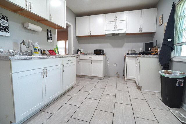 kitchen with white cabinets and plenty of natural light