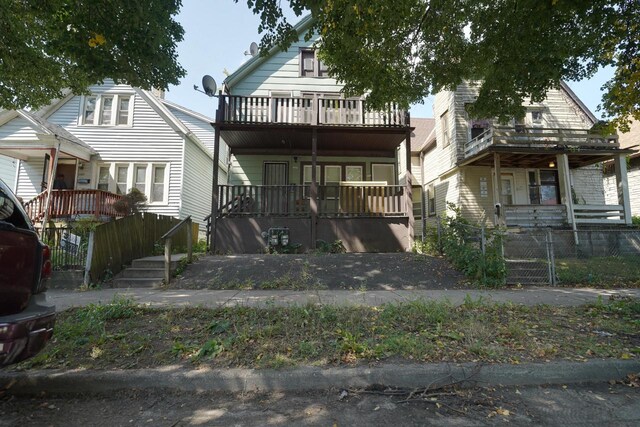 view of front of property with a balcony and covered porch