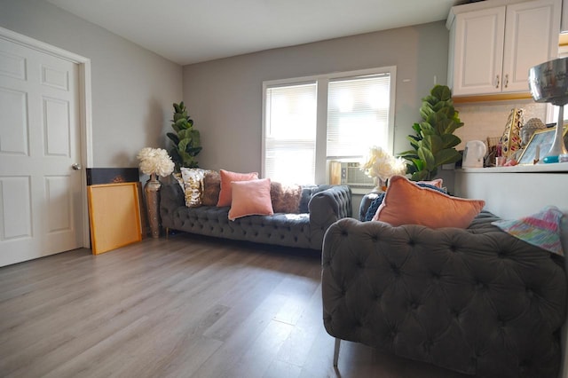 living room with cooling unit and hardwood / wood-style floors