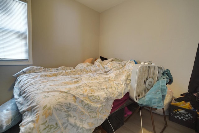 bedroom with hardwood / wood-style floors and vaulted ceiling