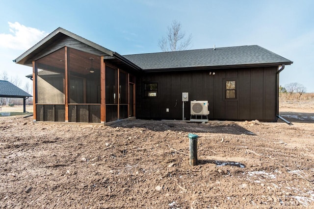 rear view of property with a sunroom