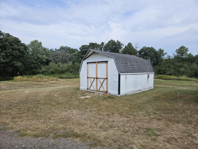 view of outdoor structure featuring a lawn