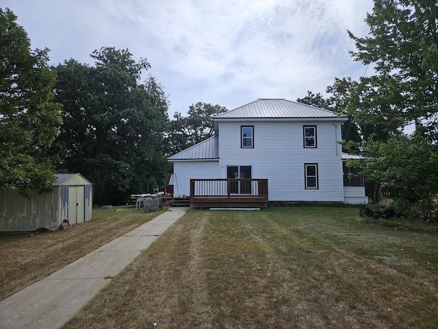 back of property featuring a wooden deck, a shed, and a yard