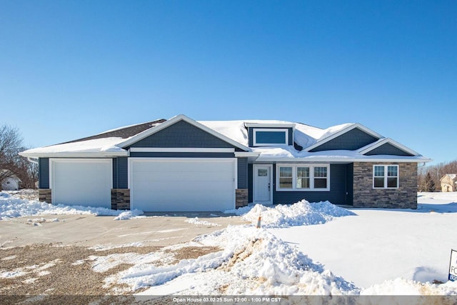 view of front of property featuring an attached garage and stone siding