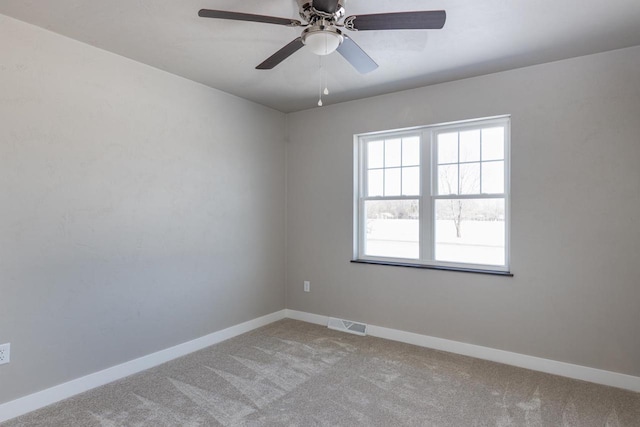 unfurnished room featuring light colored carpet, ceiling fan, visible vents, and baseboards