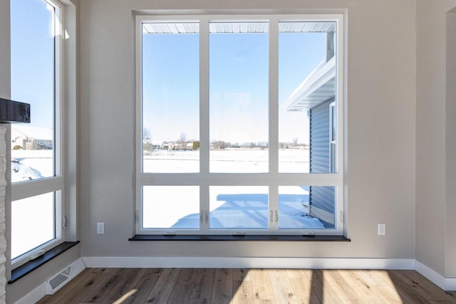 interior details with visible vents, baseboards, and wood finished floors